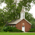 Red brick chapel by river